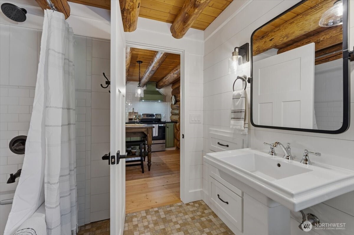 2350 First Crk Road Chelan, WA 98816 - Photo 26 of 39 a bathroom with a sink a mirror and a shower