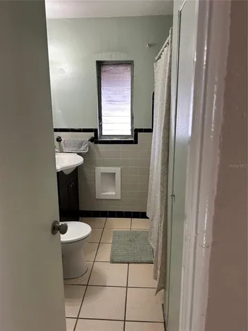 a bathroom with a sink toilet and mirror