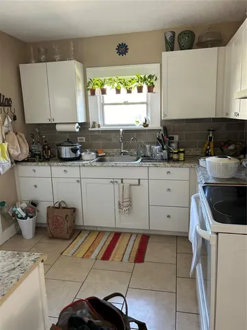 a kitchen with a sink and cabinets