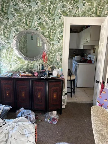 a bedroom with a bed and a mirror