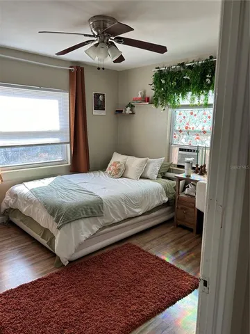 a bedroom with a bed and a window