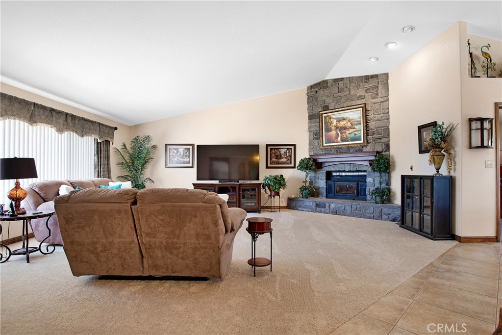 9275 Rattlesnake Road Phelan, CA 92371 - Photo 12 of 68 a living room with furniture a flat screen tv and a fireplace