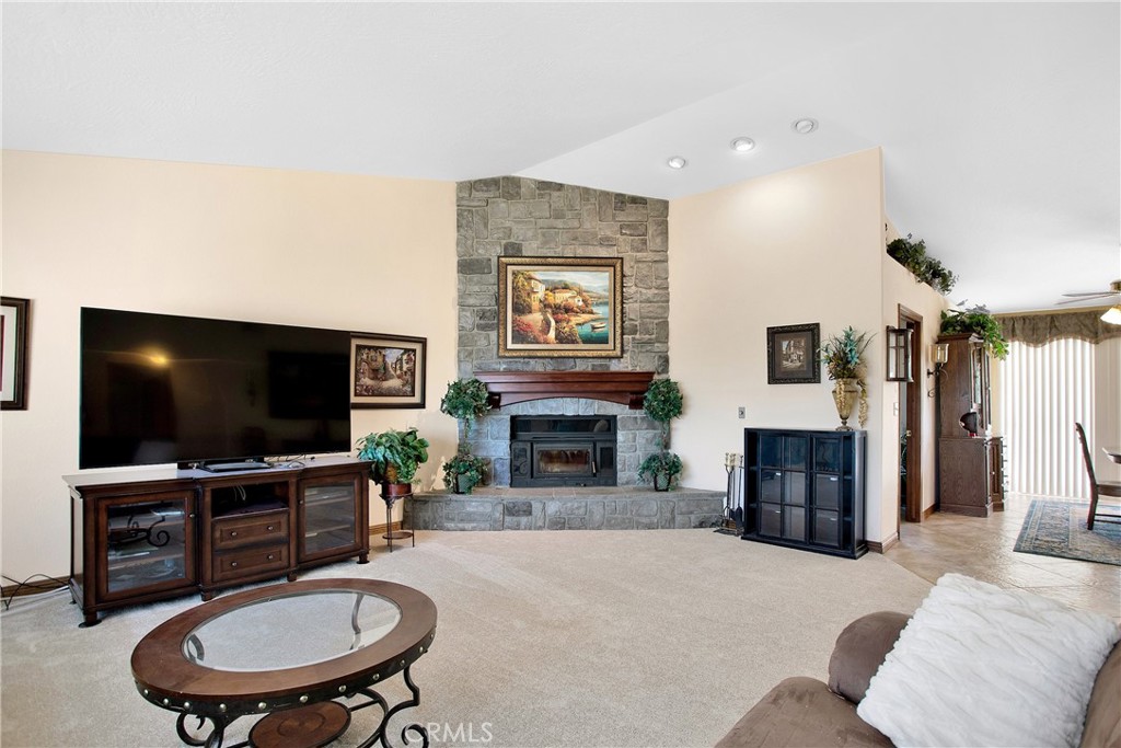 9275 Rattlesnake Road Phelan, CA 92371 - Photo 13 of 68 a living room with furniture a flat screen tv and a fireplace