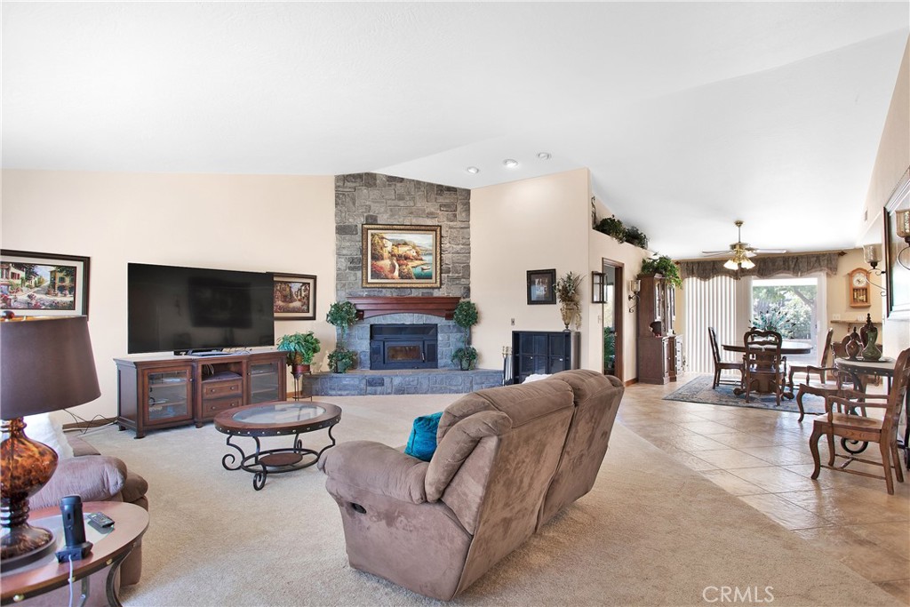 9275 Rattlesnake Road Phelan, CA 92371 - Photo 15 of 68 a living room with furniture a flat screen tv and a fireplace