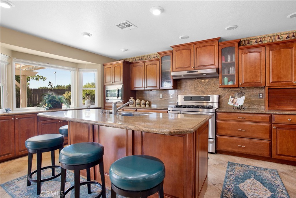 9275 Rattlesnake Road Phelan, CA 92371 - Photo 20 of 68 a kitchen with stainless steel appliances granite countertop a sink and cabinets