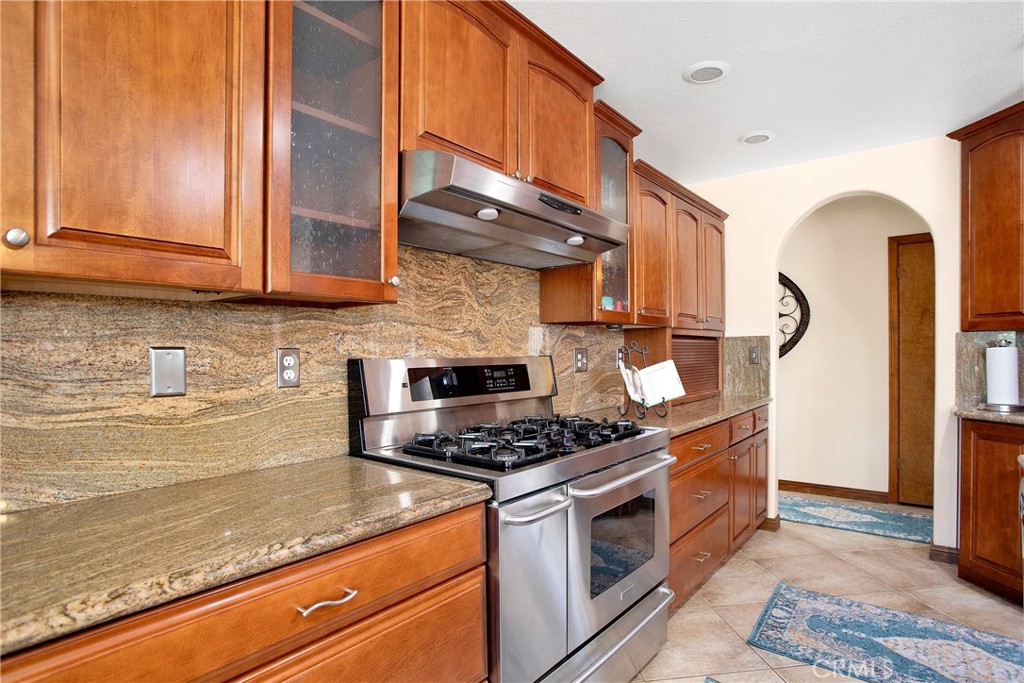 9275 Rattlesnake Road Phelan, CA 92371 - Photo 23 of 68 a kitchen with stainless steel appliances granite countertop a stove a sink and a microwave