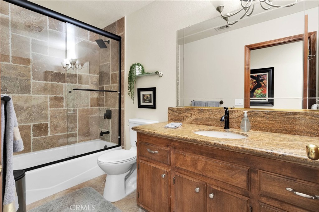 9275 Rattlesnake Road Phelan, CA 92371 - Photo 25 of 68 a bathroom with a granite countertop sink mirror vanity and toilet