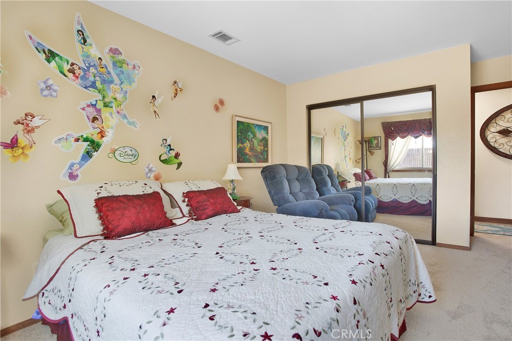 9275 Rattlesnake Road Phelan, CA 92371 - Photo 29 of 68 a bedroom with a bed and a mirror