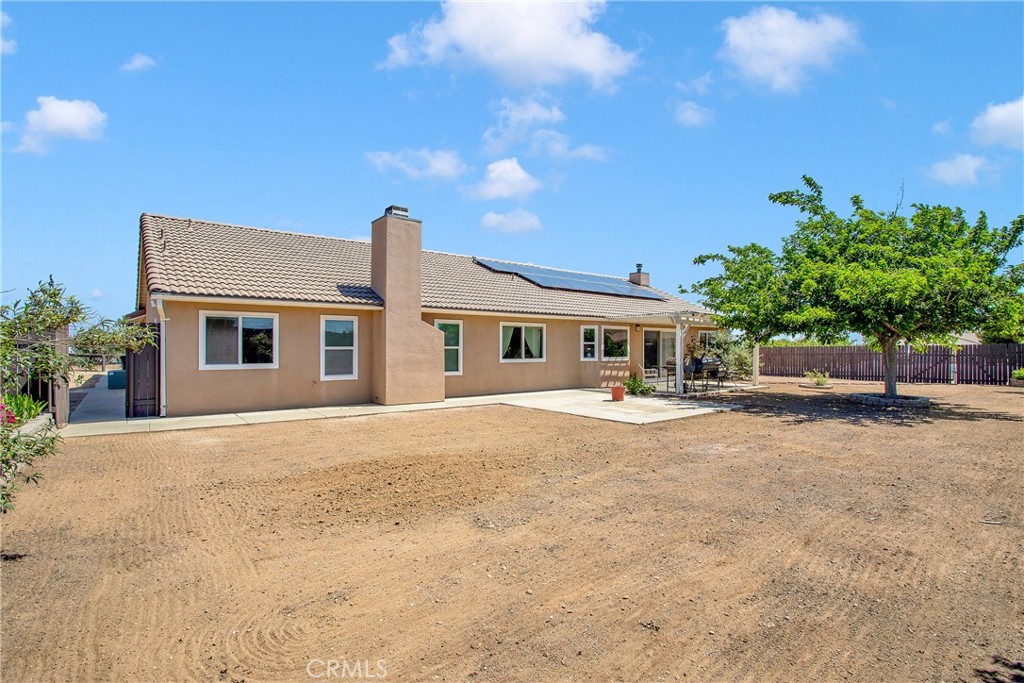 9275 Rattlesnake Road Phelan, CA 92371 - Photo 49 of 68 a front view of a house with a yard and garage