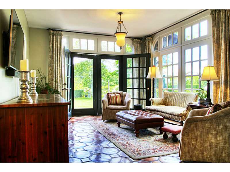 144 Wapping Road Portsmouth, RI 02871 - Photo 16 of 25 Den/Family/Great Room. Southern light pours in through mullioned windows and doors lead to a patio for outdoor dining.