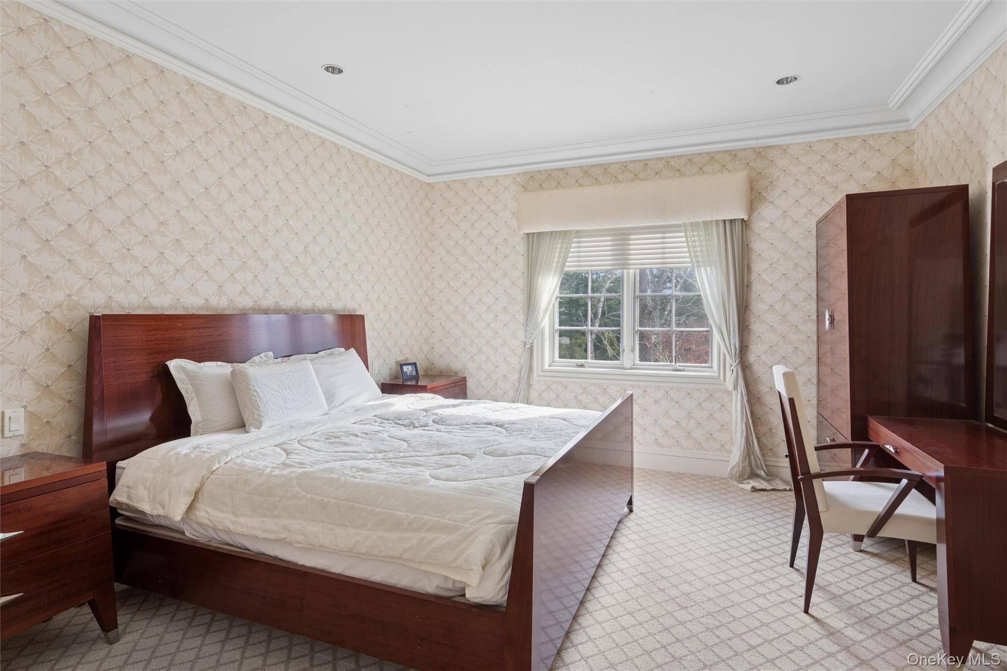 22 Willow Road Woodmere, NY 11598 - Photo 11 of 27 a bed room with a bed tv and a window