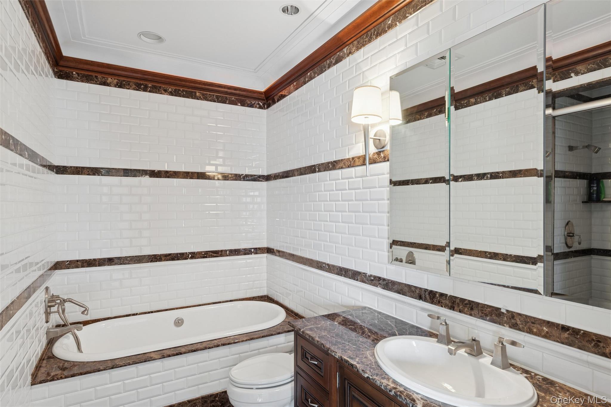 22 Willow Road Woodmere, NY 11598 - Photo 15 of 27 a bathroom with a granite countertop sink mirror vanity and toilet