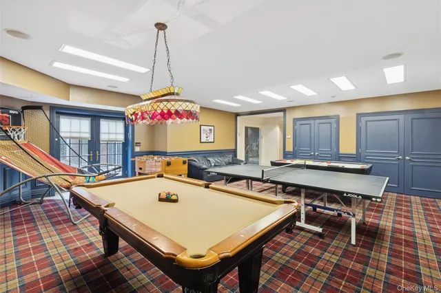 a room with pool table and windows