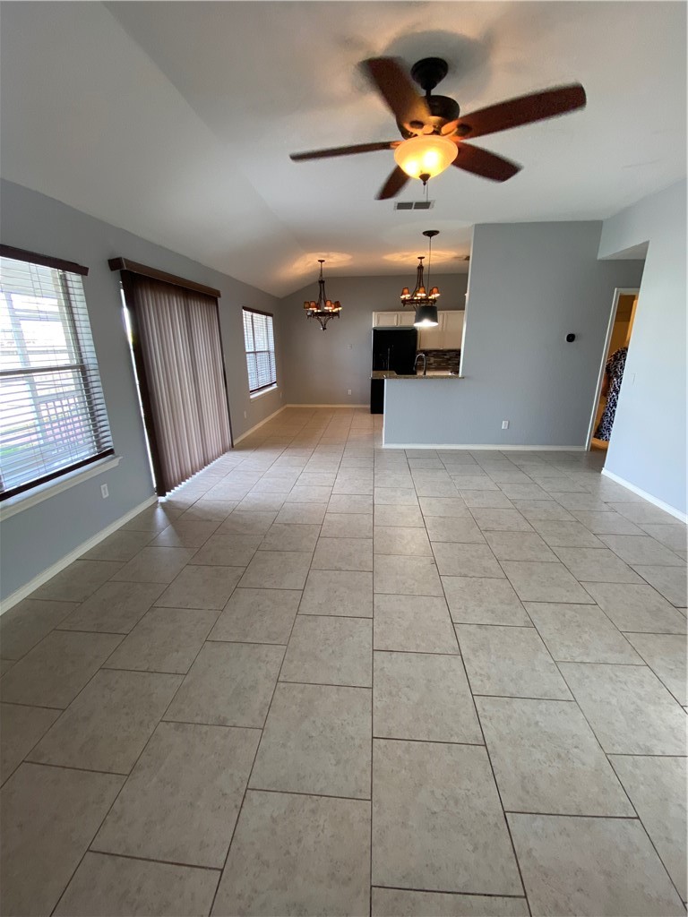 15517 Cruiser Street, Unit B Corpus Christi, TX 78418 - Photo 2 of 25 a view of an empty room with a ceiling fan and window