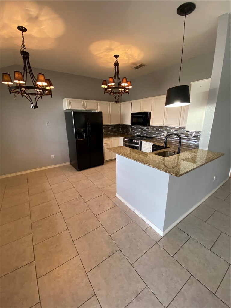 15517 Cruiser Street, Unit B Corpus Christi, TX 78418 - Photo 3 of 25 a kitchen with a sink a stove and a microwave