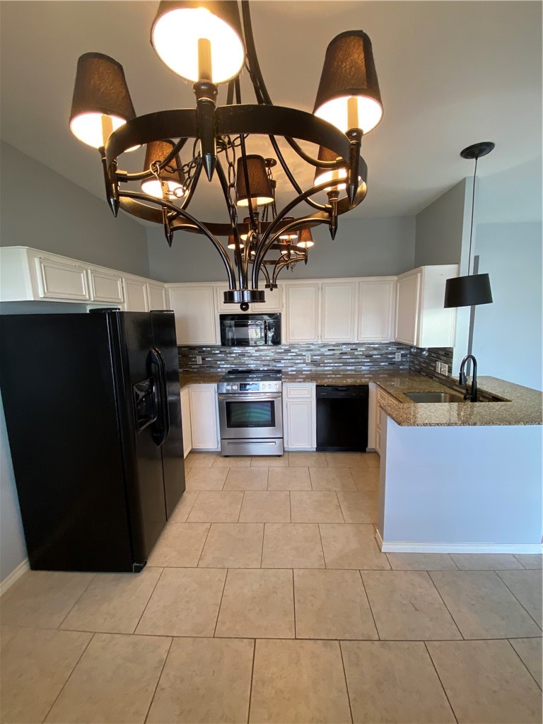 15517 Cruiser Street, Unit B Corpus Christi, TX 78418 - Photo 4 of 25 a kitchen with stainless steel appliances granite countertop a stove and a sink