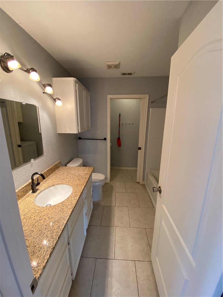 15517 Cruiser Street, Unit B Corpus Christi, TX 78418 - Photo 6 of 25 a bathroom with a granite countertop sink mirror and bathtub