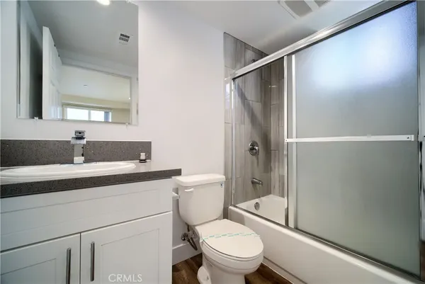 a bedroom with a bed and a potted plant