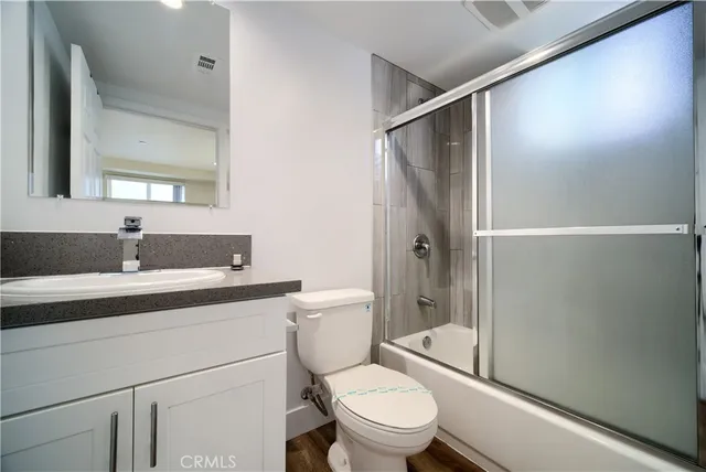 a bedroom with a bed and a potted plant