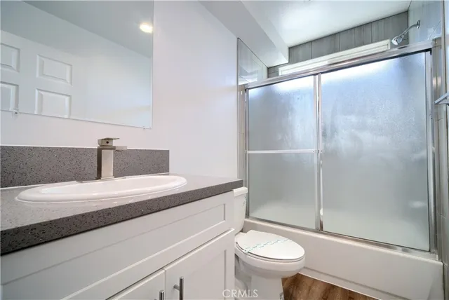 a bedroom with bed and a potted plant