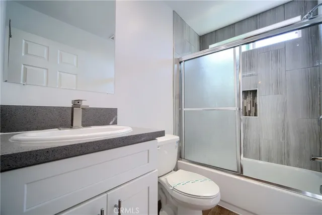 a bedroom with a bed and a potted plant