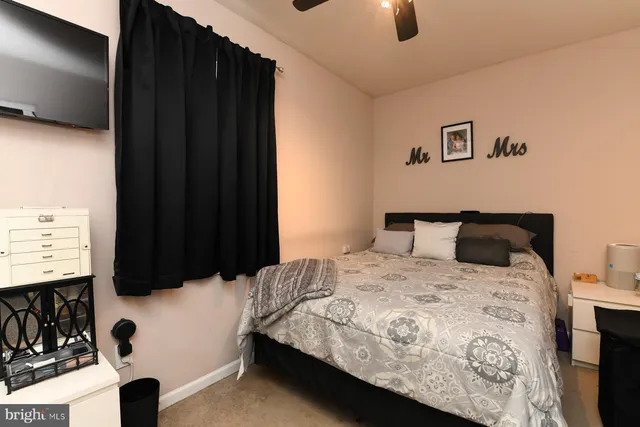 a bedroom with a bed and a flat tv screen