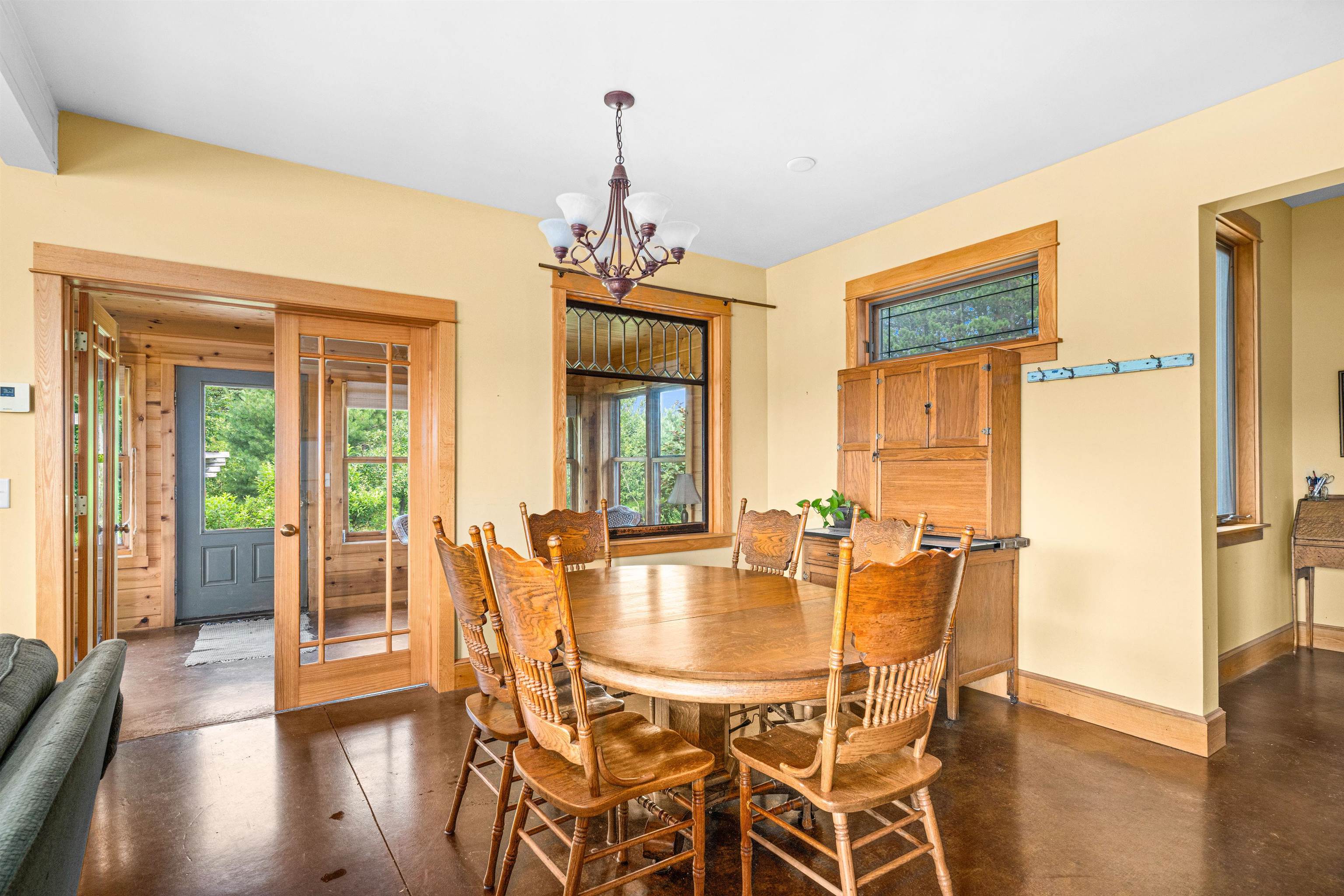 374 Nelson Road Cloquet, MN 55720 - Photo 12 of 33 Dining area with a chandelier, finished concrete flooring, and french doors