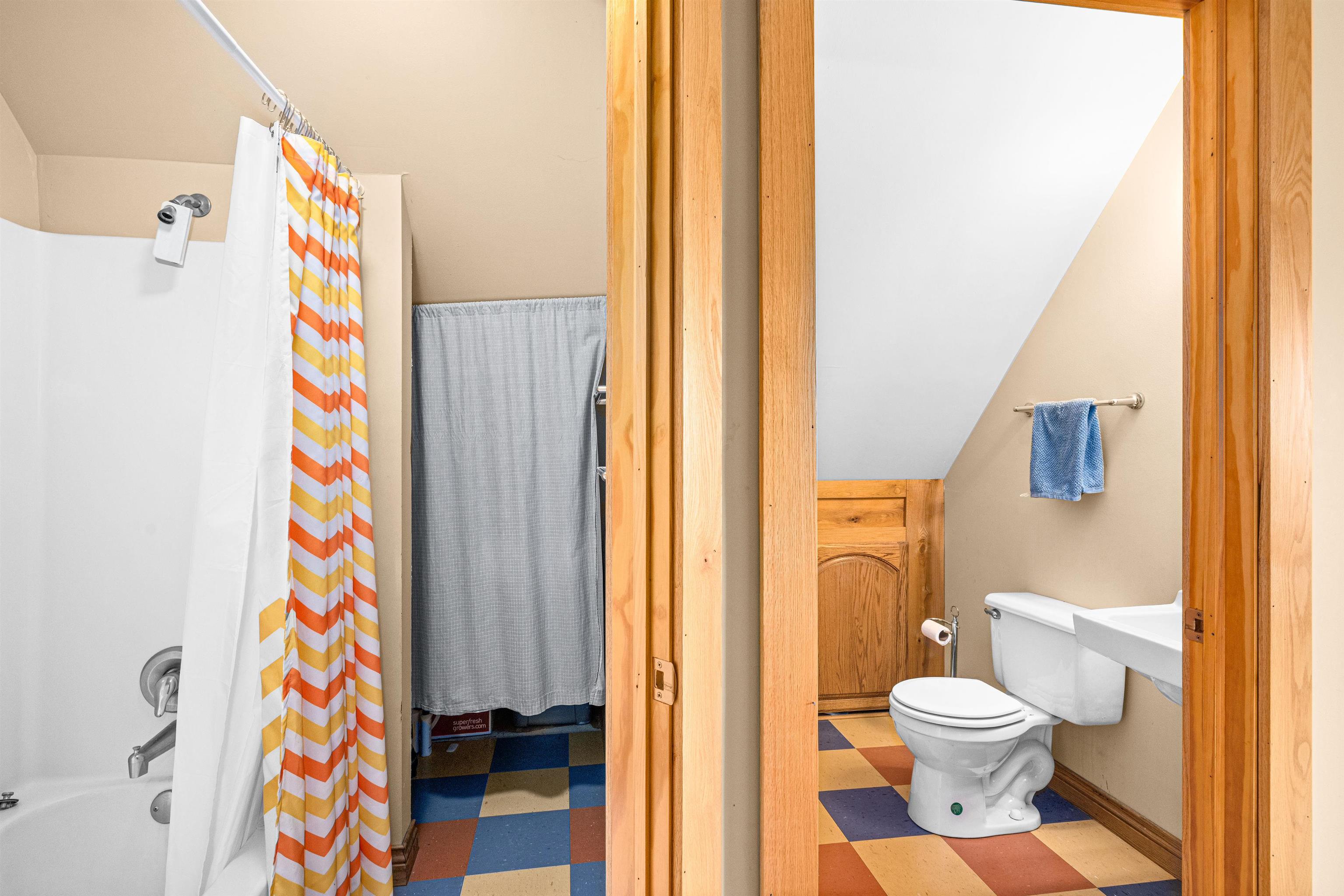 374 Nelson Road Cloquet, MN 55720 - Photo 23 of 33 Full bath featuring shower / bath combo with shower curtain, tile patterned floors, and lofted ceiling