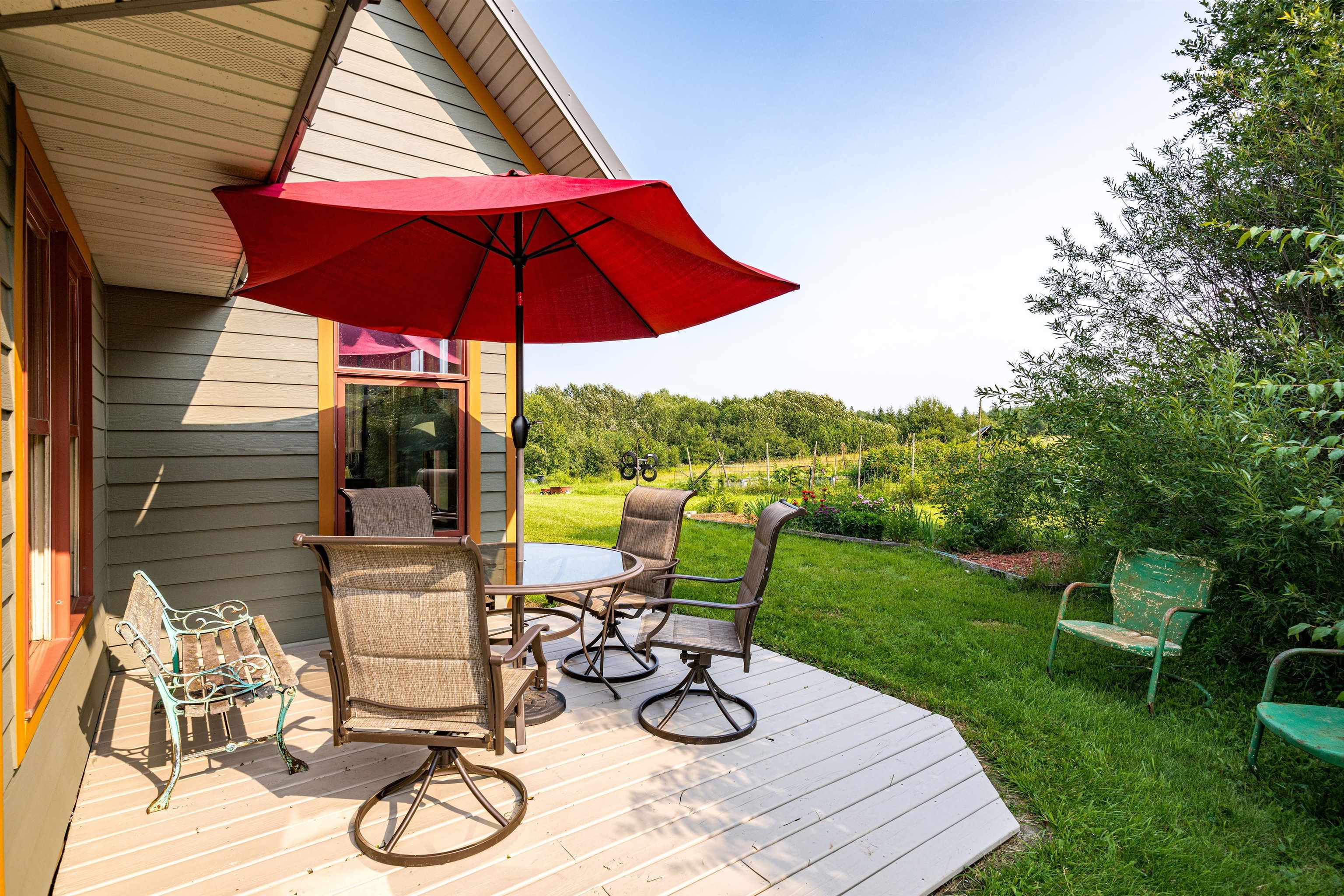 374 Nelson Road Cloquet, MN 55720 - Photo 3 of 33 Wooden deck featuring outdoor dining space and a lawn