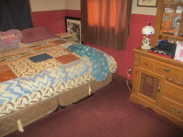 a bedroom with a bed and a dresser