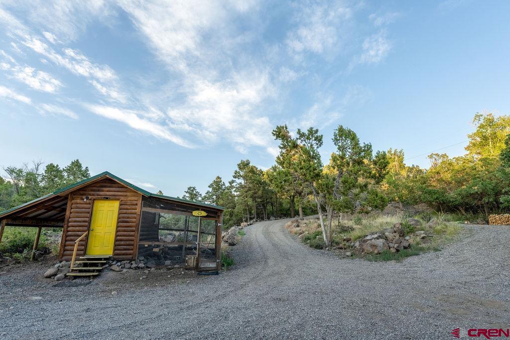 19595 Surface Creek Road Cedaredge, CO 81413 - Photo 21 of 28 a backyard of a house with table and chairs
