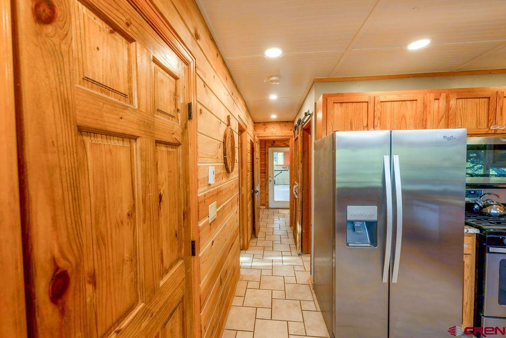 19595 Surface Creek Road Cedaredge, CO 81413 - Photo 8 of 28 a metallic refrigerator freezer sitting in a kitchen