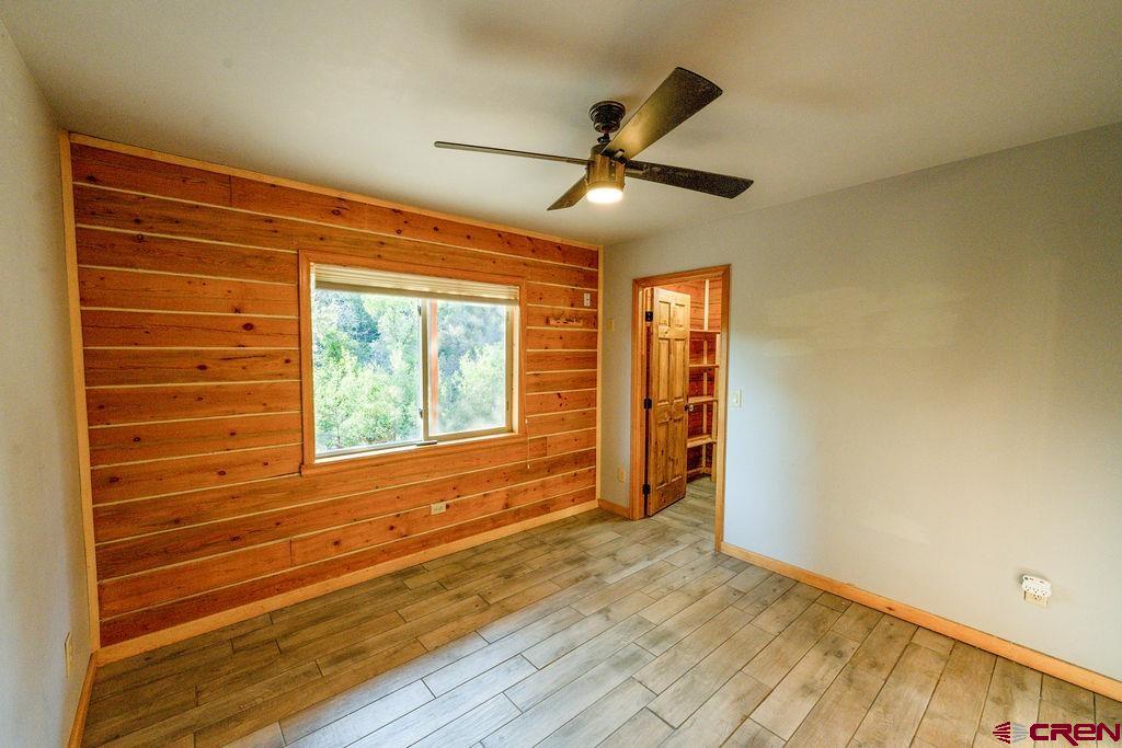 19595 Surface Creek Road Cedaredge, CO 81413 - Photo 9 of 28 a view of empty room with wooden floor and fan
