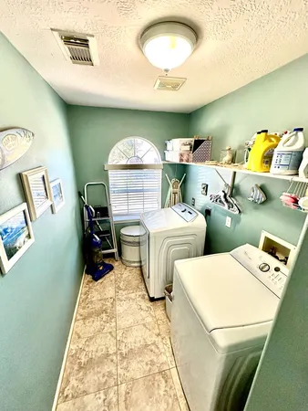 a bed room with two bed and a lamp