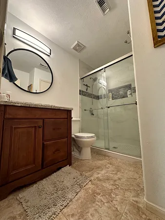a bathroom with a toilet a sink and a mirror