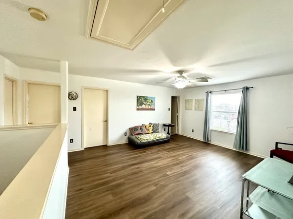 a view of a livingroom with hardwood floor and a ceiling fan