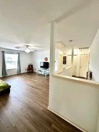 a view of a living room hardwood and kitchen