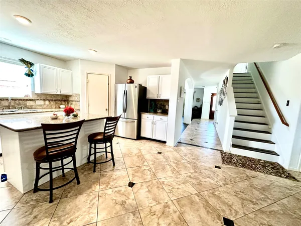 a open kitchen with a table and chairs in it