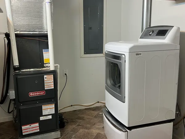a close view of a storage and utility room with washer and dryer