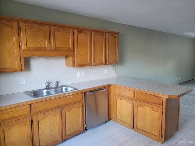 a kitchen with sink cabinets and window