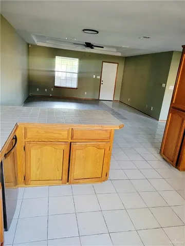 a room with a sink a stove and a window