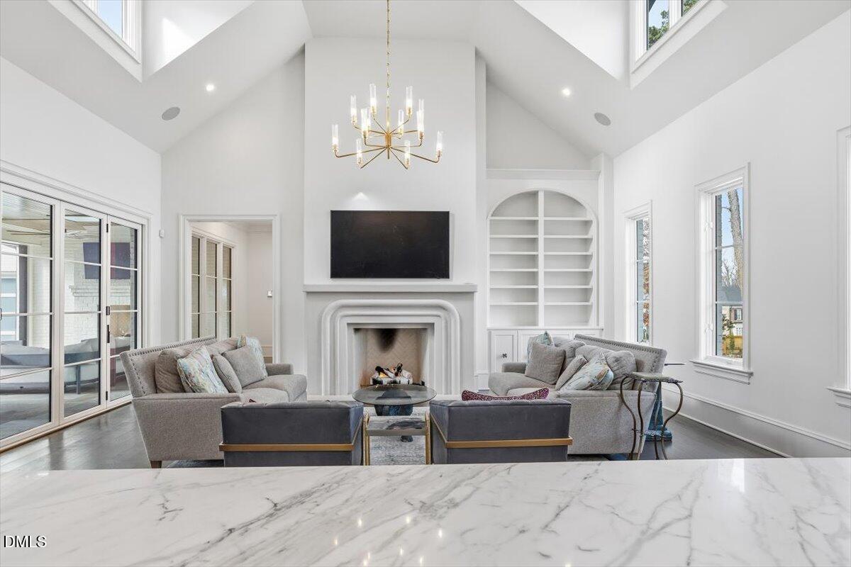 2123 St Marys Street Raleigh, NC 27608 - Photo 14 of 76 a living room with furniture a fireplace and a chandelier