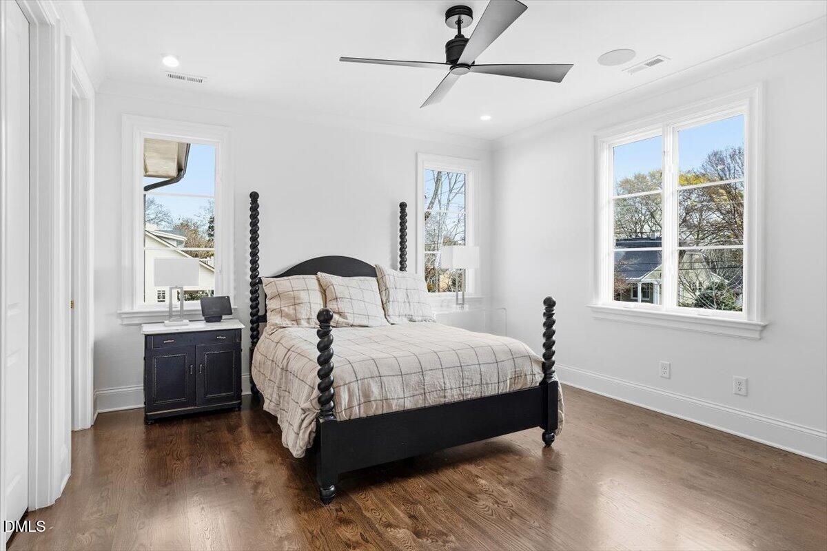 2123 St Marys Street Raleigh, NC 27608 - Photo 44 of 76 a bed sitting in a bedroom next to a window