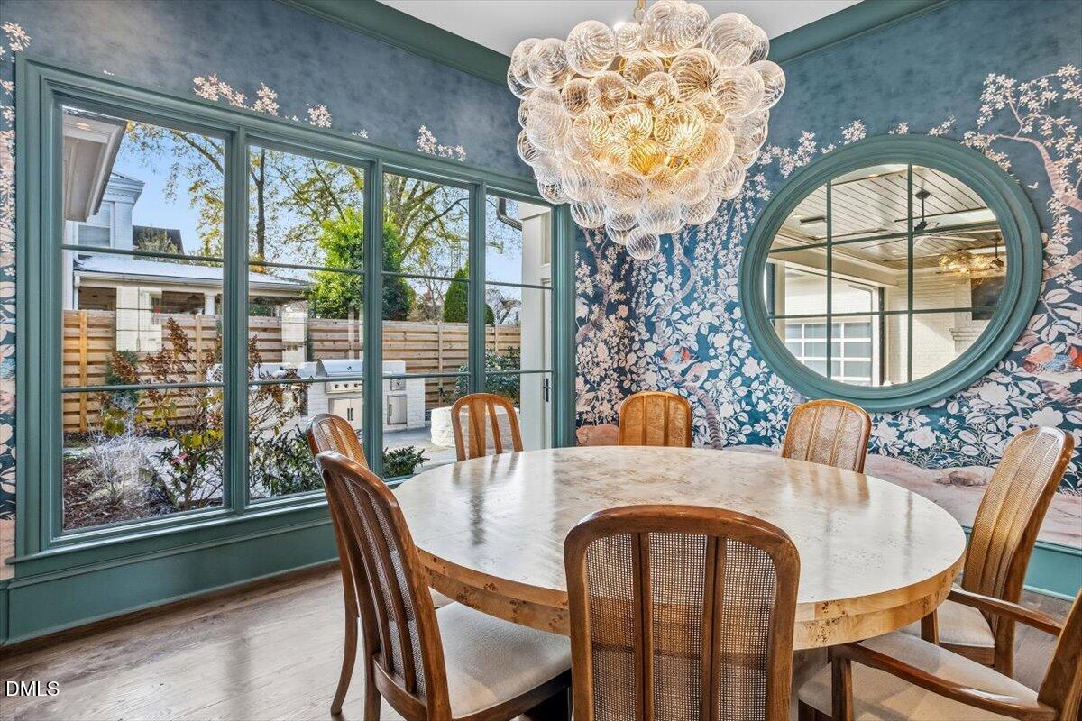 2123 St Marys Street Raleigh, NC 27608 - Photo 5 of 76 a dining room with furniture a chandelier and a rug