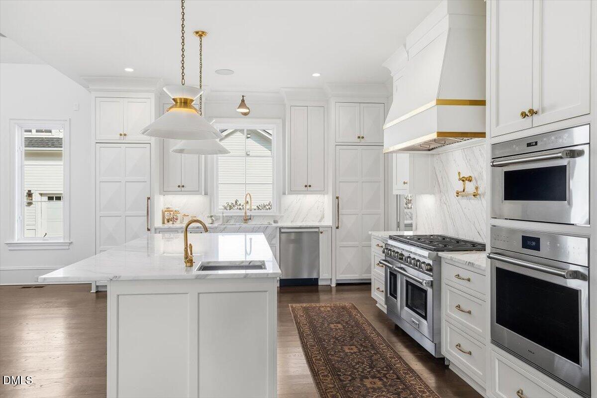 2123 St Marys Street Raleigh, NC 27608 - Photo 9 of 76 a kitchen with a sink stove and white cabinets