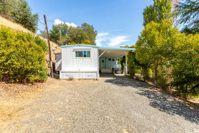 a view of a house with a yard and garage