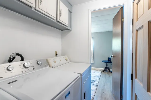 a view of wooden door and bench in wooden floor