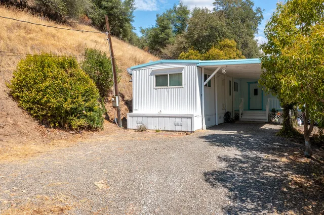 a view of a house with a yard and garage