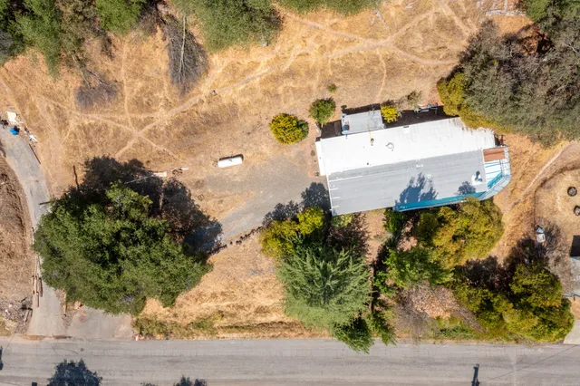 an aerial view of a house with a yard