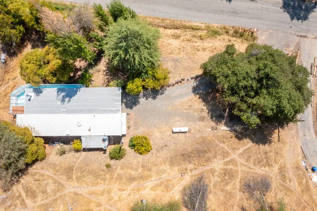 an aerial view of a house with a yard